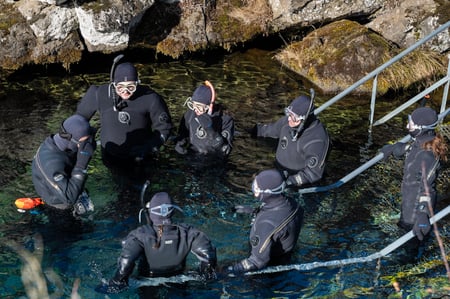 Group of people in dry suit about to go in the Silfra waters