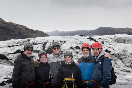 Happy family on during a glacier hike tour in Iceland