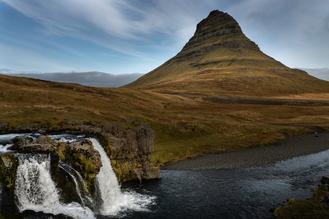 Two waterfalls are flowing before the majestic mountain of Kirkjufell
