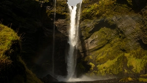 The thin waterfall of Kvernufoss nestled inside of a canyon