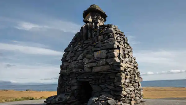 Statue made of individual stones and forming a representation of a viking