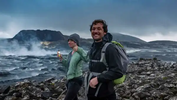 Two Happy Hikers in front of a steaming lava field