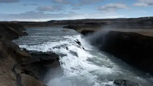 An immense waterfall is flwing down a canyon