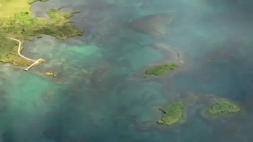 Clear blue turquoise lake seen from above, in a helicopter