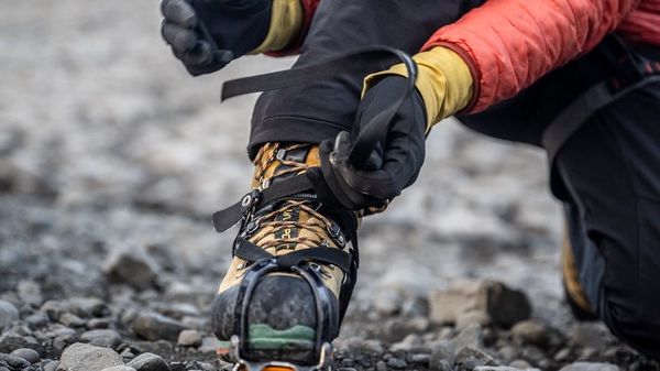 Small group of adventurers with certified glacier guide in ice cave