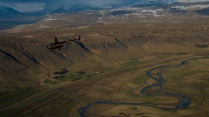 Aerial view of Iceland's dramatic landscape with waterfalls and volcanic terrain