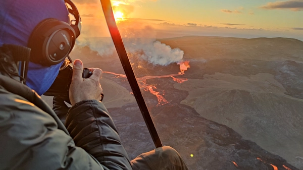 Passengers take pictures during an helicopter tour over an icelandic volcano