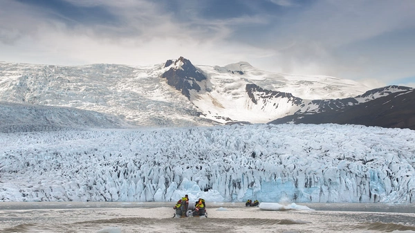 Close-up encounter with massive blue iceberg from boat perspective