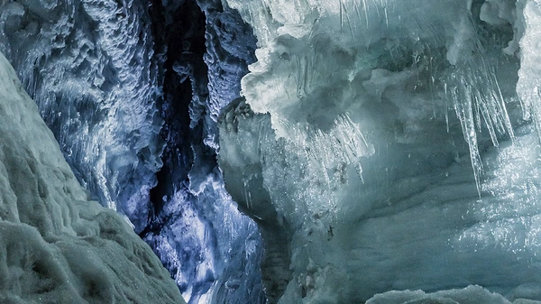 Crystal clear ice walls and formations inside the glacier cave