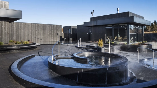 Relaxing in naturally heated pools at Krauma with countryside views