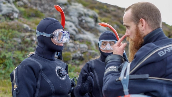 People listening to their diving instructor before snorkeling in Silfra