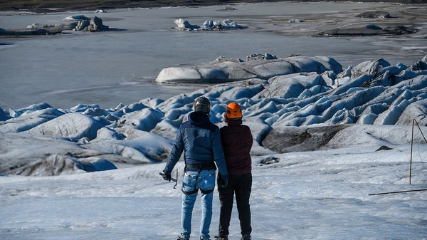 Professional photographer capturing glacier adventure moments for small group