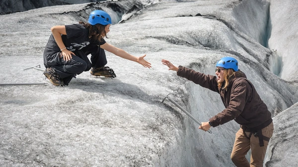 Small group receiving glacier education from certified guide on ancient ice