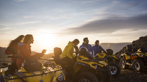 ATV riders conquering mountain peaks with panoramic Icelandic views