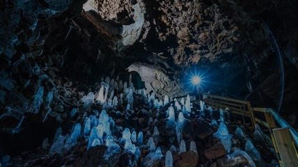 Professional lighting illuminating stunning Viðgelmir lava tube formations