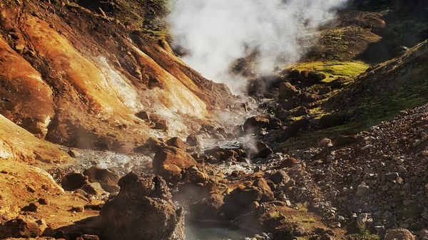 Thrilling river crossing during extreme ATV adventure with mountain backdrop