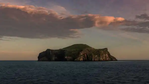 Sunset over a green island