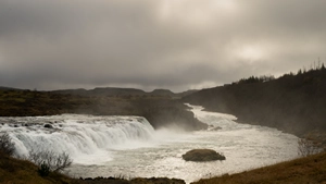 Wide Faxafoss waterfall cascading over volcanic rock