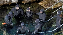 Group of people in dry suit about to go in the Silfra waters