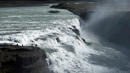 The immense Gullfoss waterfall with people by its side