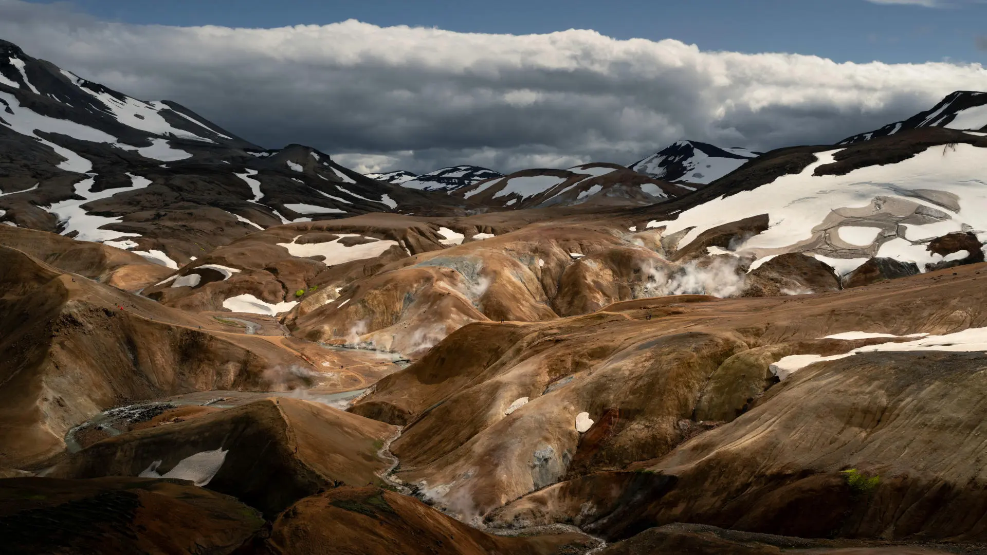 Steam is coming out of colourful mountains