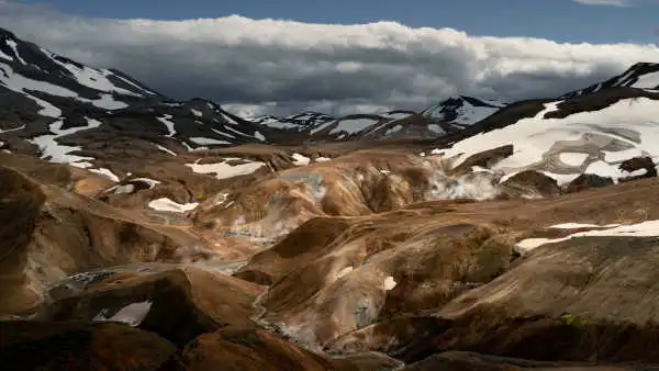 A hot geothermal area inside the mountains, which are steaming all around