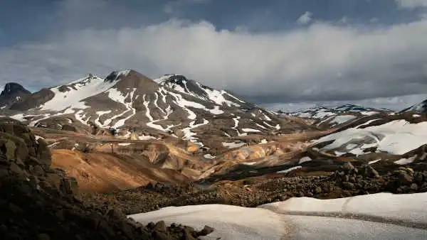 Colourful and steaming mountains photographed under a bright blue sky