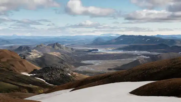 Panorama over braided rivers, fumarolles, orange and green mountains