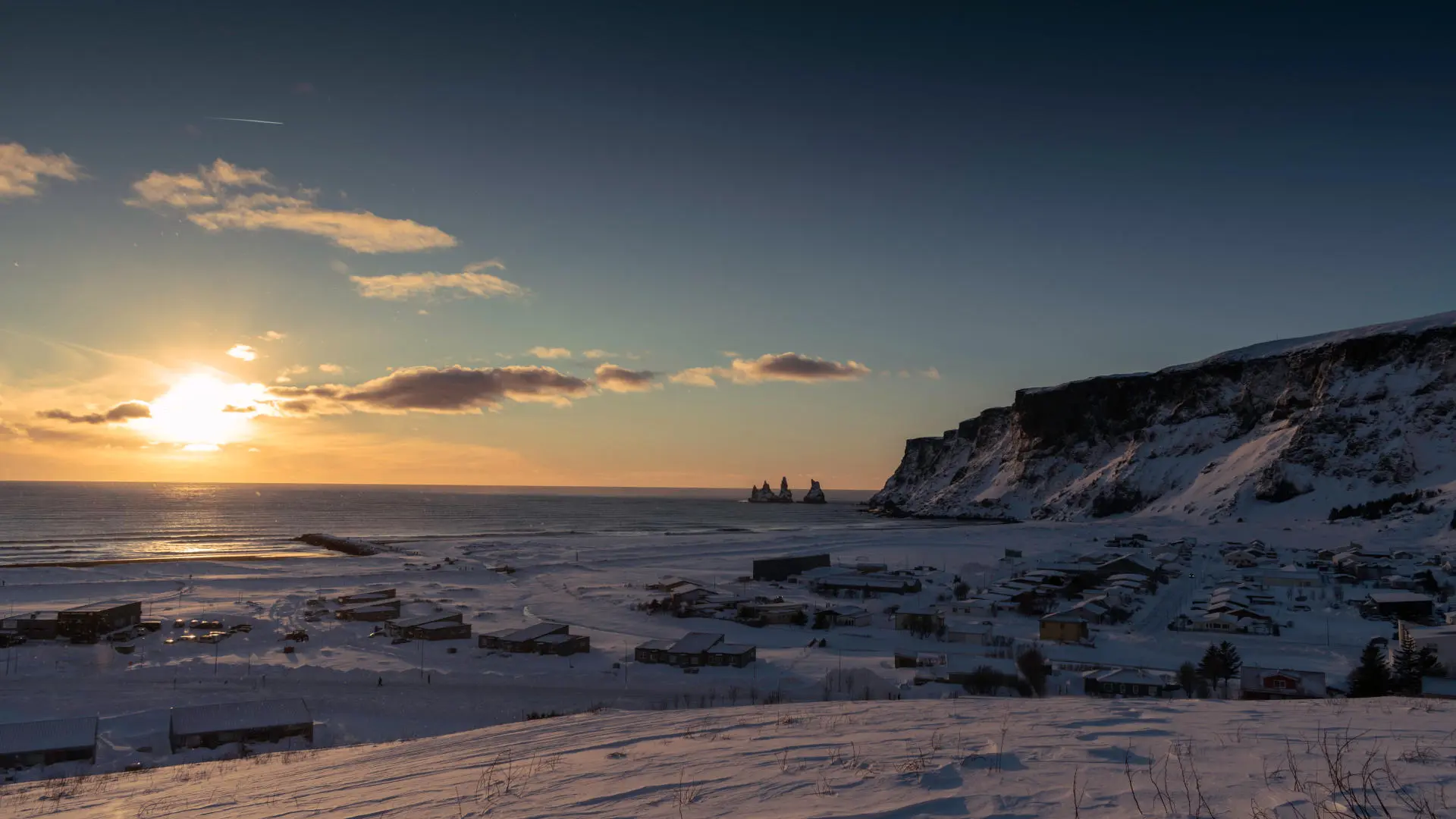 Picture of cliffs and sea pillars during sunset in the wintertime, wehen everything is covered in snow