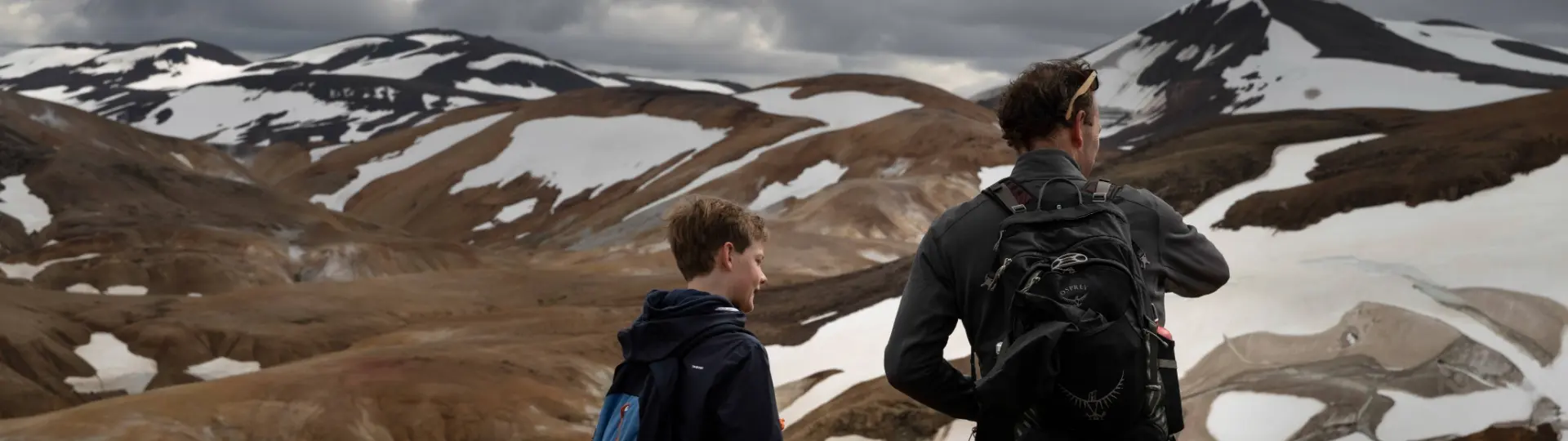 Father and son looking at mountains