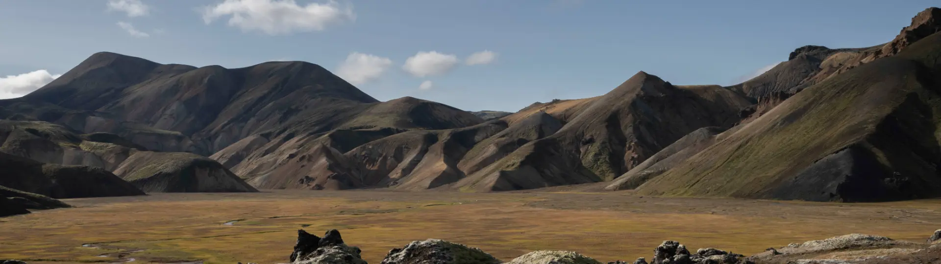 colourful mountains with a lava field in the foreground