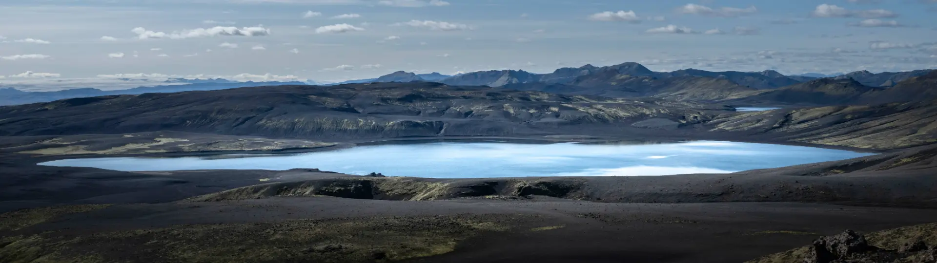 Blue lake in the middle of green mountains