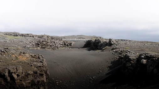 A person is under the bridge between Europe and America on the Reykjanes Peninsula.