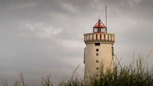 The lighthouse of Garður seen through the grass