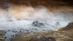 An immense puddle of mud is steaming and boiling in Seltún Hot Springs