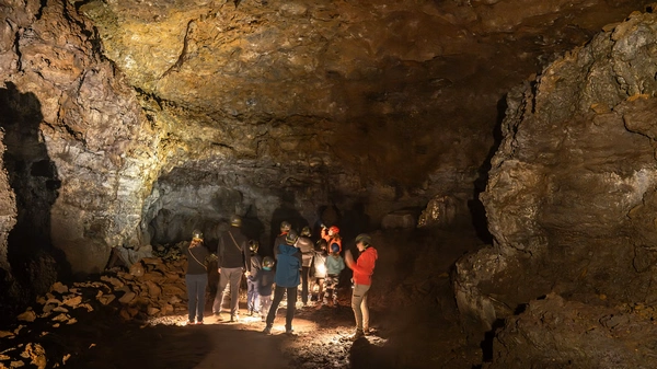 People underground exploring an old lava cave