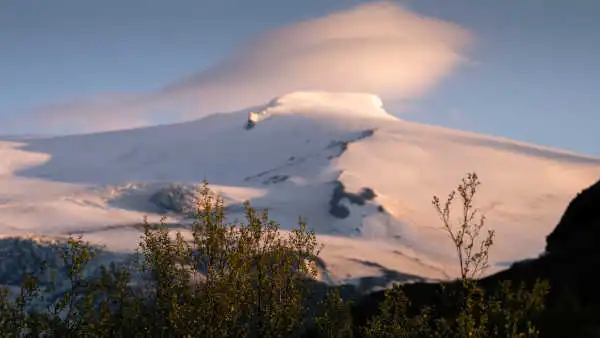 Glacier over a volcano under the sunset