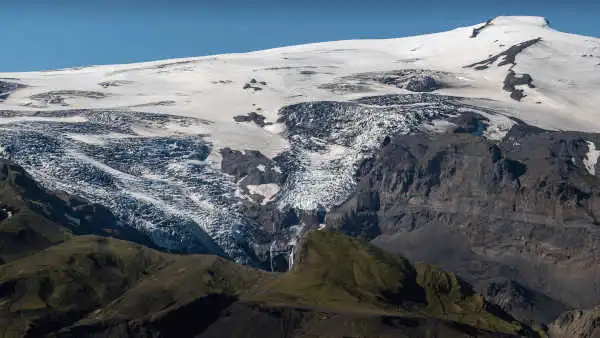 View over a glacier and a lush valley