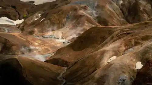 Beautiful colorful mountains with steaming hot springs all around